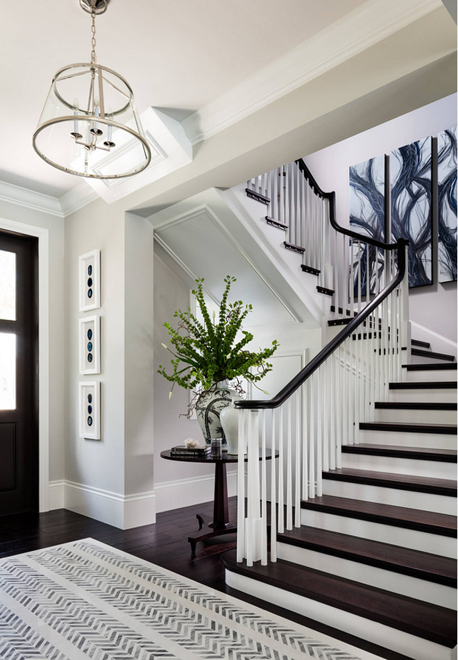 Foyer Dark Hardwod Floors, Foyer Dark Hardwod Floors, dark staircase wood steps, foyer dark stained staircase railing. Benjamin Moore Stonington Gray #Foyer #DarkHardwodFloors #HardwodFloors #darkstaircaserailing #darkstaircasewoodsteps #foyerdarkhardwood #staircase #railing. #BenjaminMooreStoningtonGray Diamond Custom Homes, Inc.