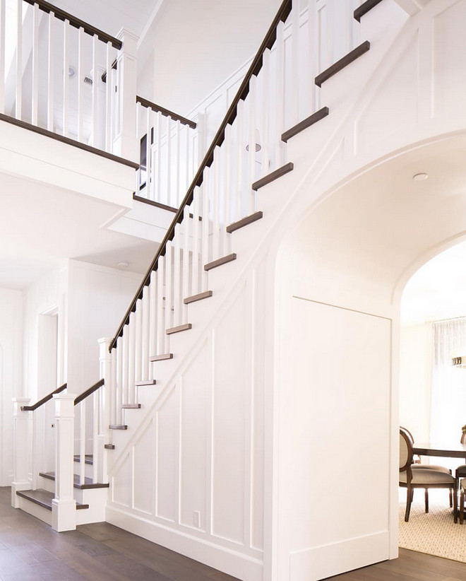 Foyer with dark hardwood floor and white paneling millwork and archway. Foyer with dark hardwood floor and white paneling millwork and archway ideas #Foyer #darkhardwoodfloor #hardwood #floor #whitepaneling #millwork #archway Brooke Wagner Design