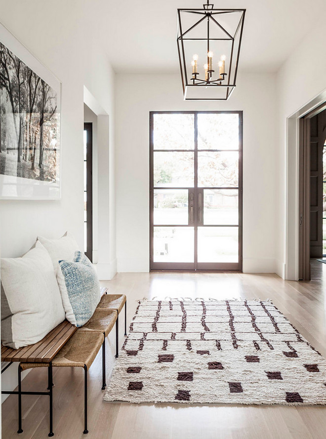 Glass and steel double front doors. Glass and steel double front doors lead to a beautifully designed foyer featuring a Darlana Medium Lantern. Glass and steel front doors are by Lincoln Windows. #Glassandsteel #frontdoor #Glassandsteelfrontdoor Coats Homes