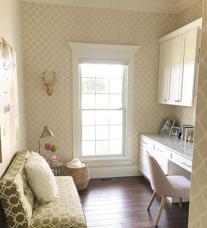 Home office. Neutral home office. Neutral home office features neutral cabinets, neutral wallpaper and hardwood floors. A green settee brings some color to the office.