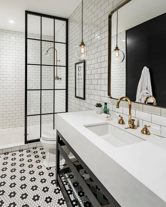 Industrial Bathroom Design. Industrial bathroom with antique brass fixtures, steel and glass shower door and steel cabinet with the thickened quartz counter. #Industrialbathroom #bathroom #steelcabinet #steelandglassshower #steelandglassshowerdoor A Finer Touch Construction,LLC 