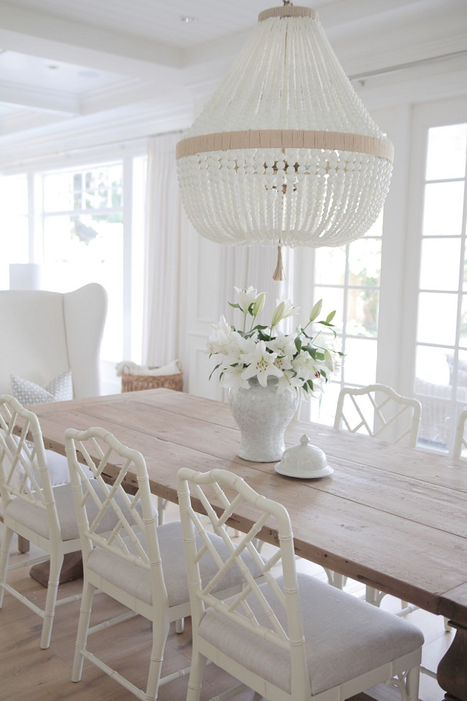Neutral Dining Room. Neutral Dining room. Neutral Dining room with reclaimed wood table, white chairs and white beaded chandeliers. #neutraldiningroom #diningroom #neutralinteriors jshomedesign