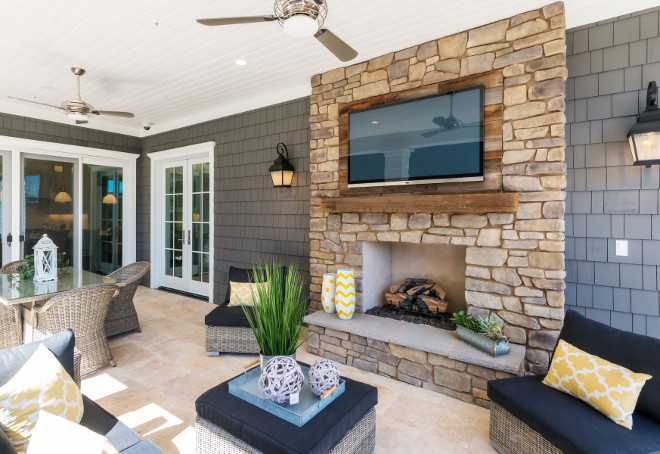Outdoor patio fireplace. The patios has a fireplace with a reclaimed wood accent wall above the reclaimed wood mantel. #outdoor #fireplace #stonefireplace #reclaimedwoodmantel