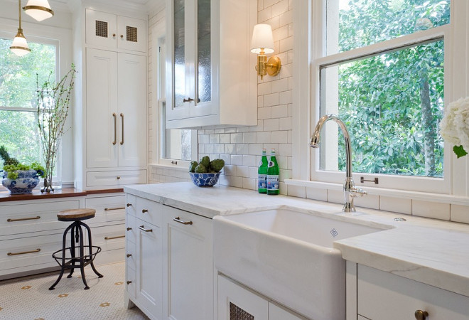 Vintage Kitchen. The highlight and starting point is the original hex tile flooring in white and gold. It was in excellent condition and merely needed a good cleaning. The addition of white calacatta marble, white subway tile, walnut wood counters, brass and gold accents keep the charm intact. Cabinet panels mimic original door panels found in other areas of the home. #VintageKitchen #Vintage #kitchen BRADSHAW DESIGNS LLC