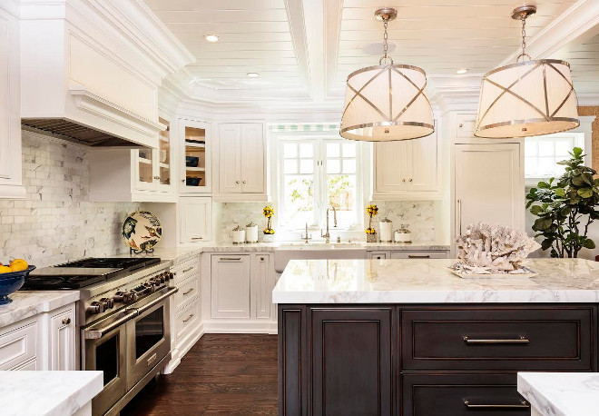White kitchen with tongue and groove ceiling. “The island cabinet color is a custom stain that the designer made based off Dunn Edwards Admiral Blue and the surround cabinets are in Benjamin Moore Super White. The walls are a Ralph Lauren wallpaper Sudan Weave Sand.” Classic White kitchen with tongue and groove ceiling. Beautiful White kitchen with tongue and groove ceiling #Whitekitchen #tongueandgroove #ceiling #TandG Barclay Butera