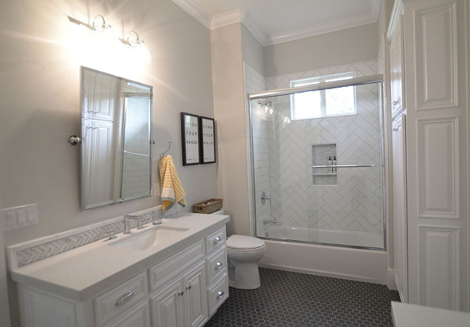 Herringbone shower tile. The designer definitely had some fun with classic tiling in this bathroom. Notice the herringbone tiles in the shower. The shower tile is 4"x12" subway with cape gray grout. #herringbone shower tile #herringbonetile #showertile Eye for the Pretty 