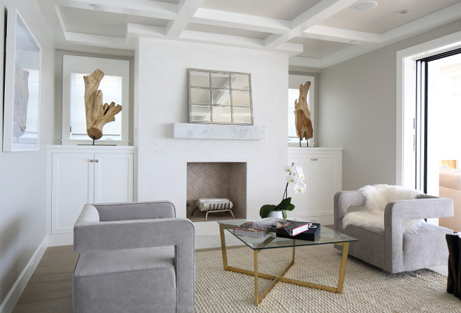 Bedroom sitting area with fireplace. Paint color is Sherwin Williams Collonade Gray. Winkle Custom Homes. Melissa Morgan Design. Ryan Garvin Photography