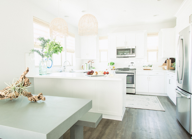 The dining area features a cement table with benches. Cement table and benches are from West Elm. california-white-kitchen-with-clean-lines-california-white-kitchen-with-clean-lines-and-crisp-cabinets-californiakitchen-whitekitchen-kitchencleanlines