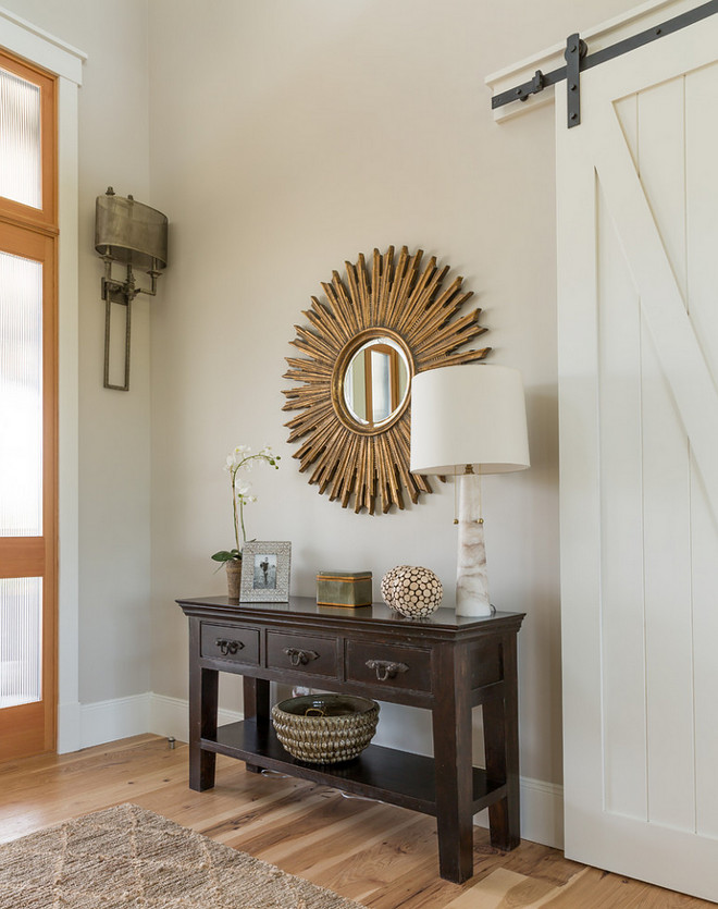 Foyer with Barn Door. This farmhouse style foyer features wide plank floors and a white barn door. Paint color is Sherwin Williams SW7029 Agreeable Gray. Barn Door Foyer. Foyer with Barn Door. Barn Door Foyer Ideas. #FoyerBarnDoor #BarnDoor #Foyer foyer-with-barn-door-barn-door-foyer Restyle Design, LLC.