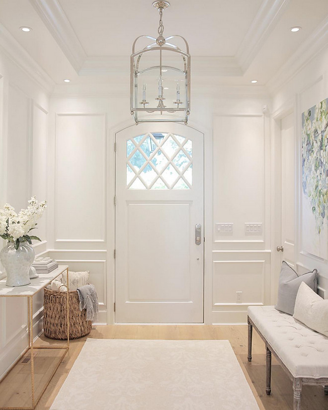 Foyer. White foyer with paneled walls, white oak floors and Circa Lighting Arched Top Lantern. #Foyer #Whitefoyer #paneledwalls #foyerpaneledwall #whiteoakfloors #CircaLightingArchedTopLantern