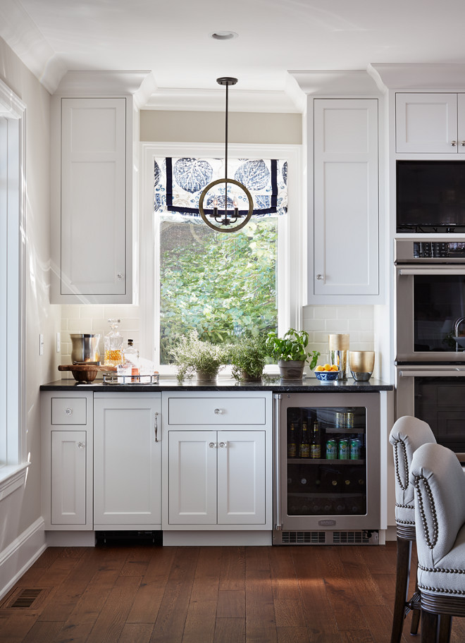 Kitchen Bar. The kitchen bar is perfect to prepare the daily beverages or to be used as a butler's pantry when entertaining. Lighting is by Kichler. Bar Countertop: Jet Mist Granite - honed. #kitchenBar #Bar #butlerspantry #lighting #countertop kitchen-bar