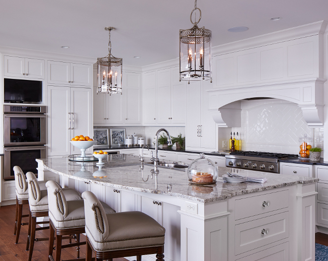 Kitchen island. This is a 10’ long island. Custom crystal hardware flaking each end. Island Countertop: Serenity Granite - Polished. Kitchen Cabinet Details: Maple painted cabinets. Inset doors, polish nickel hardware. Soft close drawers. Lighting is by Hudson Valley. #kitchenisland #kitchen #island Vivid Interior Design. Hendel Homes 