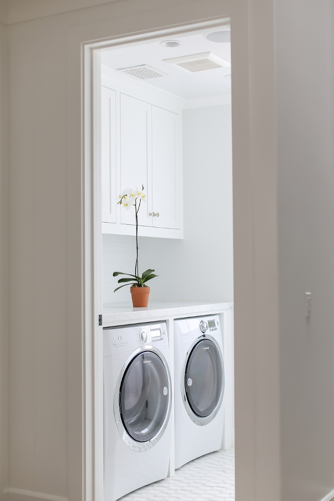 Laundry Room. Practical laundry room with neutral color palette. Laundry room appliances are Washer: Electrolux 4.4 Cu. Ft. Front Load Washer with Wave-Touch® Controls featuring Perfect Steam. Color: Island White. Dryer: Electrolux 8 CU.FT Gas Steam Dryer - Wave-Touch Control. Color: Island White. Winkle Custom Homes. Melissa Morgan Design. Ryan Garvin Photography