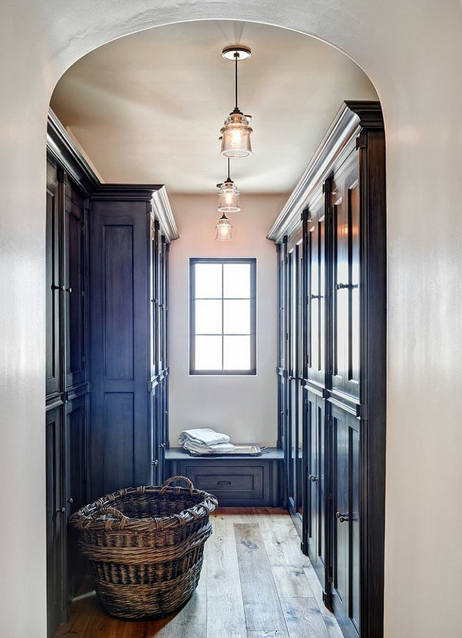 mudroom-wood-floor-and-cabinets-with-doors-archway-opens-to-mudroom-with-wide-plank-hardwood-floor-and-built-in-cabinets-with-doors-the-refined-group