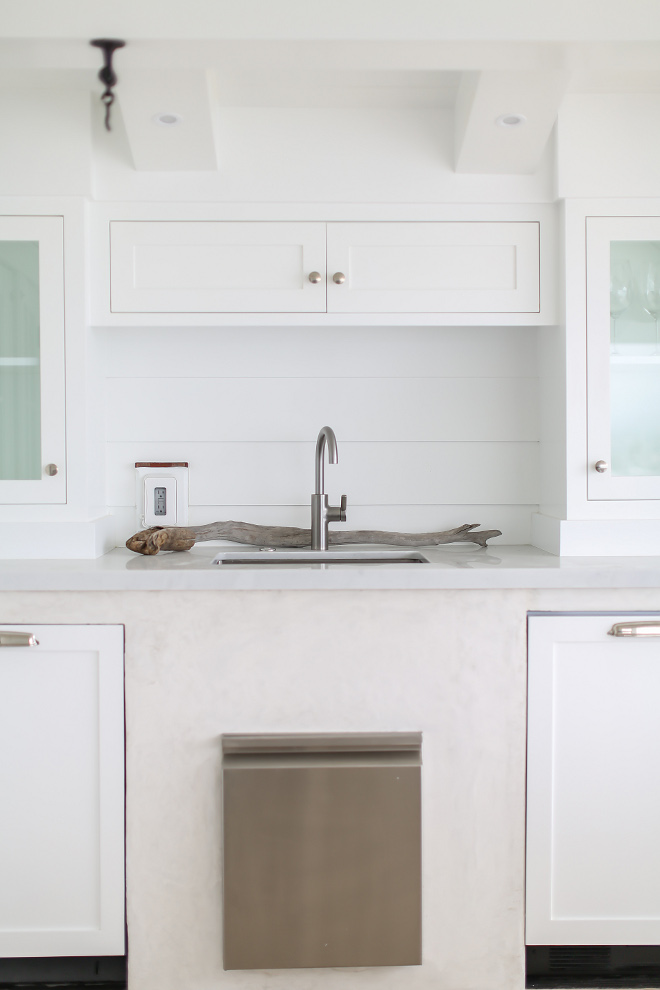 Outdoor white kitchen with shiplap backsplash. Ice maker is by Subzero. Winkle Custom Homes. Melissa Morgan Design. Ryan Garvin Photography