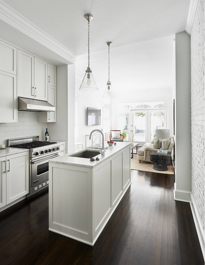 All white small narrow kitchen painted in Benjamin Moore PM-1 Super White. Small white kitchen paint color Benjamin Moore PM-1 Super White #smallkitchen #allwhitekitchen #narrowkitchen #BenjaminMoorePM1SuperWhite Stuart Nordin Designpm-1-benjamin-moore