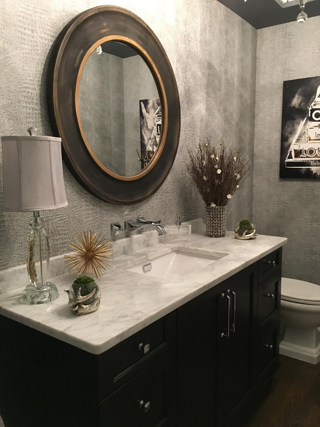 Powder Room. I wanted this room to be memorable. Guests are in this space for a short period of time and it can go unnoticed or make a huge statement. I chose to do metallic crocodile embossed wallpaper to add interest and texture to the walls, without doing a busy pattern. We did a trayed ceiling with rope lighting in the crown moulding to highlight the dark gray dramatic ceiling. I did a chandelier instead of sconces to make the room elegant. I was less concerned with adequate lighting since it is just a powder room and more interested in creating a mood, so the chandelier is on a dimmer. Another unique feature is the wall mounted faucet and undermount sink. Beautiful Homes of Instagram Sumhouse_Sumwear