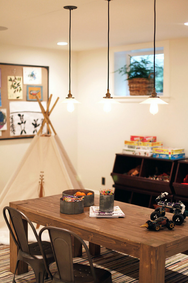 Rustic Industrial Playroom. The table and chairs are part of the Restoration Hardware line for kids. Pendants are Hudson Valley Lighting 3102-OB-008 Vintage Old Bronze Pendant. Rustic Playroom with industrial lighting #RusticPlayroom #industriallighting H2 Design and Build