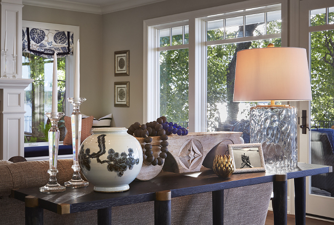 Sofa Table. A sofa table by Currey & Co. features a glass table lamp, antique pottery, wooden pedestal and handmade sea glass beads. sofa-table #sofaTable #consoletable #curreyandco Vivid Interior Design. Hendel Homes