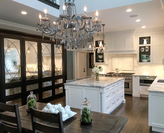 White Kitchen with dark stained pantry cabinet.