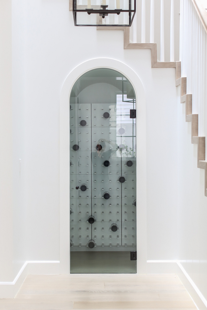 Wine room under stairs. Wine room under stairs feature floating GETSTACT wine racks with back lighting, and cooling system #wineroom #undertstairs #understairswineroom #winecellar #glasswineroom #glasswinecellar Winkle Custom Homes. Melissa Morgan Design. Ryan Garvin Photography