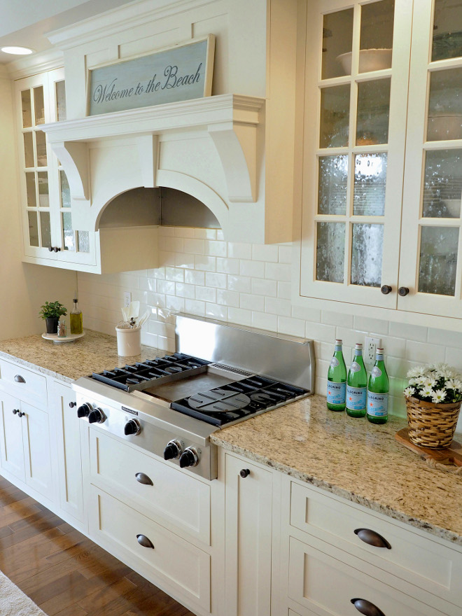 Ivory Kitchen cabinet paint color and backsplash. The Sherwin Williams paint color closely matching to the cabinet paint color is Dover White #SW6385. The off-white subway tiles are slightly irregular cut with an uneven surface. Home Bunch Beautiful Homes of Instagram wowilovethat