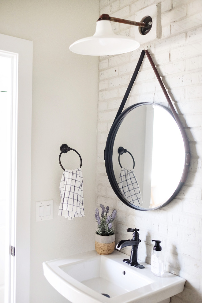 Brick accent wall. Farmhouse bathroom with brick wall. Bathroom with brick accent wall. Bathroom with brick accent wall. Wall paint color is Benjamin Moore Classci Gray. #brickwall #paintedbrick #Benjaminmooreclassicgray #brickaccentwall #bathroom #brick #wall bathroom-brick-wall Beautiful Homes of Instagram @nc_homedesign via Home Bunch