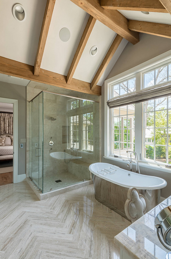 Bathroom with vaulted beamed ceiling and large herringbone floor tiles. The large herringbone floor tiles were supplied by Walker Zanger. bathroom-vaulted-beamed-ceiling #bathroom #vaultedceiling #vaultedbeamedceiling #largeherringbonetile Allan Edwards Builder Inc