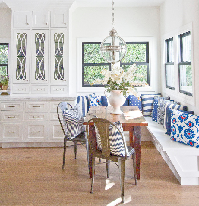 Breakfast nook with farmhouse table. Because the kitchen offered limited areas for color, I used our eat-in nook as a great way to mix things with the addition of an old barn wood table. A balance of white on white and the addition of these rustic furnishings seemed the perfect finish to this cozy space. #farmhousetable #breakfastnook #nook Home Bunch Beautiful Homes of Instagram Bryan Shap @realbryansharp