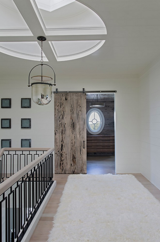 Catwak with skylight and Lighting is Urban Electric Smokebell Pendant. Notice the Pecky Cypress barn door. catwalk-with-shiplap-walls-custom-stairway-railing-skylight-and-pecky-cypress-barn-door Herlong & Associates Architects + Interiors