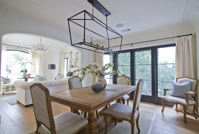 Dining room. This room was approached with a less-is-more concept. Our updated traditional dining excudes a fresh and timeless look – achieved through gracious touches, classic silhouettes and well-styled accents. Wall paint color is "Benjamin Moore White Dove". Pendant: Darlana Linear Pendant. Dining Table & Chairs: Restoration Hardware. If you look closely, you can see the original 1920’s plaster detail just on the inside of the original barrel ceiling of this room. Artwork: Vintage Flea-Market Find. dining-room Home Bunch Beautiful Homes of Instagram Bryan Shap @realbryansharp