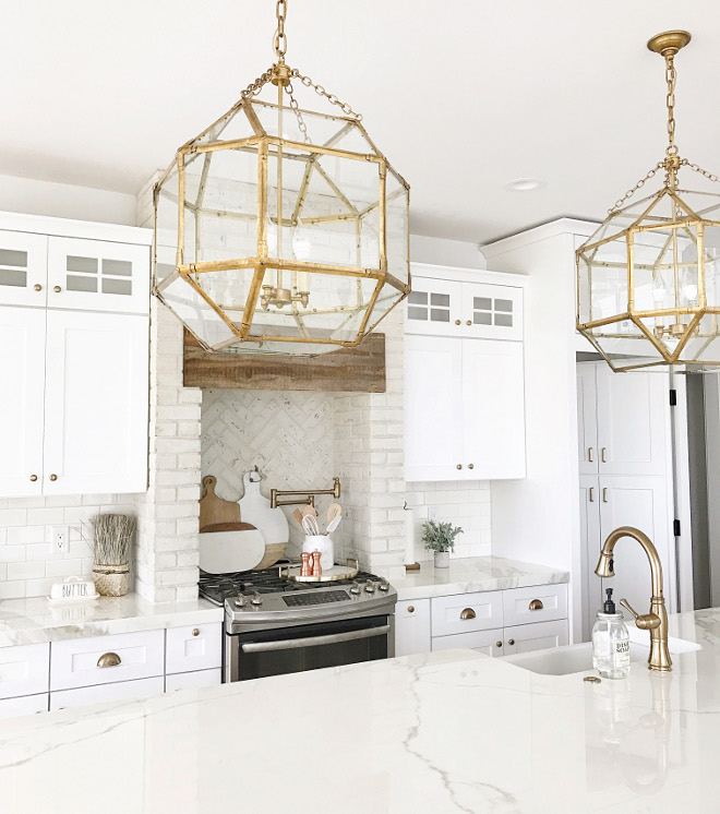 Modern Farmhouse Kitchen. Farmhouse Kitchen. Even though I went with brass for hardware and light fixtures, I still needed that 'country' touch to the kitchen. That being said, we went with brick for the hood and added a piece of barn wood. #Modernfarmhousekitchen #Farmhousekitchen #farmhouse #kitchen #barnwood #reclaimedwood #wood #brick #brickhood #paintedbrick #farmhouseinteriors Beautiful Homes of Instagram @nc_homedesign via Home Bunch