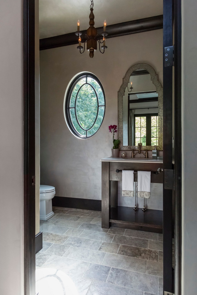 French Bathroom. Powder room features a custom Oak vanity. Countertop is honed granite. Chandelier is Currey and Co. Knotworth Chandelier. #Frenchbathroom #bathroom #powderroom Hendel Homes