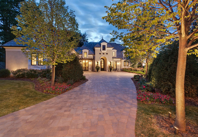 French Home. Built by one of my favorite builders in Minnesota, Hendel Homes, this home is a mix of French sophistication and rustic modern. The lake house embraces the French architecture on the exterior with roof lines, limestone sills, metal window details, and clean stucco. The front showcases wood trellises and garage doors and a paver driveway. Around back there is a beautiful entertaining area with a fountain, built in grill, fireplace, and multiple seating areas. The main level has the all the amenities for one level living, including the master suite. In the lower level there are 2 more bedrooms, a craft room, another kitchen and greatroom, for guest to have their own private space. This home is in an amazing community called Locust Hills with dock slips on Lake Minnetonka and a pool club house. french-home-exterior Hendel Homes