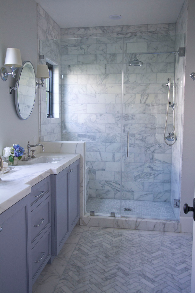 Master bath. The master bath embraces charm and functionality. A prominent display of polish and shine with the mirrors and sconces give this space a bit more elegance, while the calacatta marble walls and floor keeps things bright and inviting. Here, we kept things simple with coastal-cool details and a classic palette. Flooring is Calacatta marble, honed tile in a herringbone pattern. herringbone-marble-floor-tile Home Bunch Beautiful Homes of Instagram Bryan Shap @realbryansharp