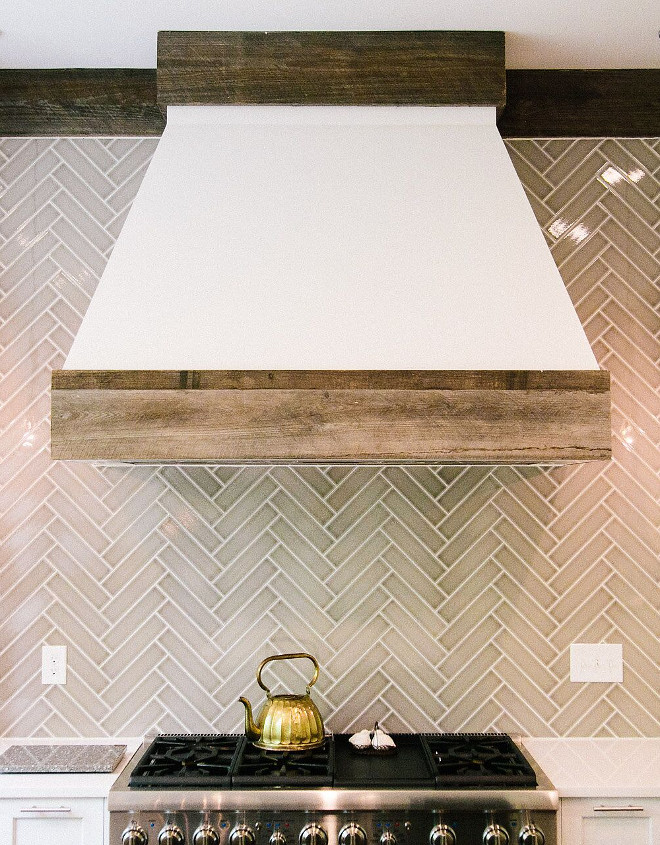 The hood is painted in Benjamin Moore Decorator's White. Reclaimed wood brings some warmth and creates a rustic feel to this kitchen. hood-with-reclaimed-wood-accents Outrageous Interiors