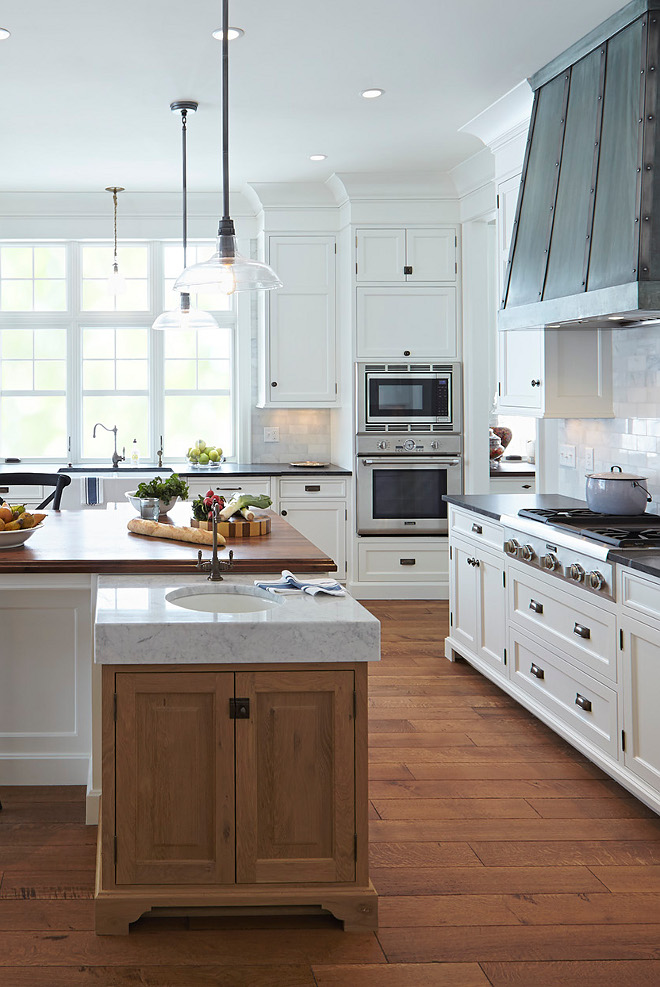 Island Prep Sink on side of island with White Oak Cabinet and Thick Marble countertop. The kitchen island mixes 5" thick slabs of marble and a rustic walnut butcher-block wood top with aged antique brass faucets and fixtures. White cabinets are maple. Perimeter countertops are Jet Mist Granite. The kitchen island prep area feature Rift & Quarter Sawn White Oak cabinets. island Prep Sink. Island Prep Sink on side of island. #Islandprepsink #islandsink #prepsink #WhiteOakCabinet #ThickMarble #countertop #ThickMarbleCountertop Island Prep Sinkisland-prep-sink Hendel Homes