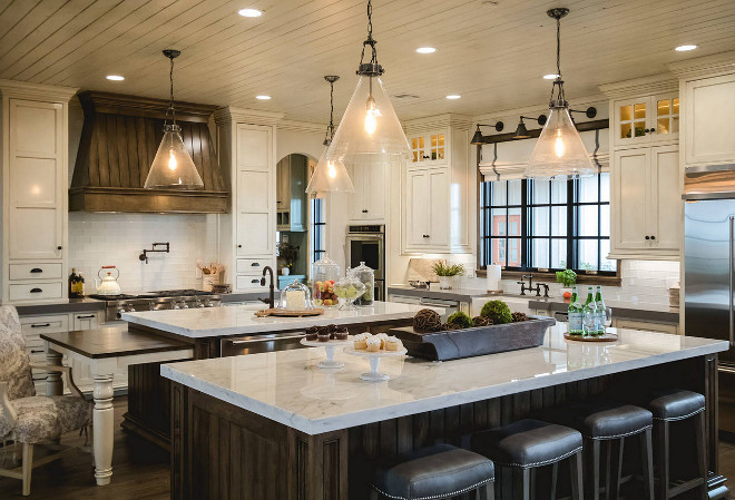 Farmhouse kitchen with two islands. White farmhouse kitchen with dark stained hood and two dark stained islands. The kitchen cabinets were Benjamin Moore White Dove with Vandyke glaze. Farmhouse kitchen with two islands #Farmhousekitchen #twoislands #twoislandskitchen #darkstainedisland #darkstainedhood #kitchen #farmhousekitchens Alicia Zupan