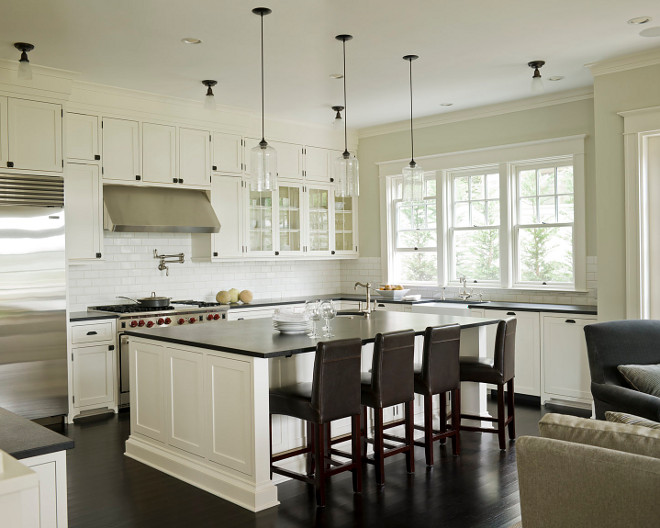 White kitchen cabinets painted benjamin Moore Cloud White, Ann sacks subway tiles backsplash, Rohl farmhouse sink, honed black granite countertop and Rohl faucet kit. off-white-kitchen-with-black-granite-countertop Susan Marinello Interiors