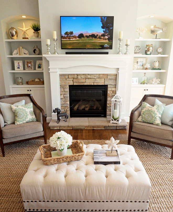 Living room fireplace, furniture and decor. Accent chairs – Carol House Furniture, St. Louis, Missouri. Candle sticks are Mercury Glass from Pier 1 Imports. Medallion pillows, Pier 1 Imports. Ottoman is Pottery Barn, however it’s been discontinued. The cabinets next to the fireplace are Shiloh Cabinetry and the color is called Polar White. #livingroom #decor #fireplace #cabinet #color #stone #ottoman #accentchairs Home Bunch Beautiful Homes of Instagram wowilovethat