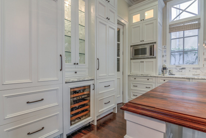 Paneled refrigerators. Paneled refrigerators flanked by beverage fridge and glass door cabinets. #Paneledrefrigerators #beveragefridge #glassdoorcabinets #kitchen paneled-refrigerators-flanked-by-beverage-fridge-and-glass-door-cabinets Matt Morris Development