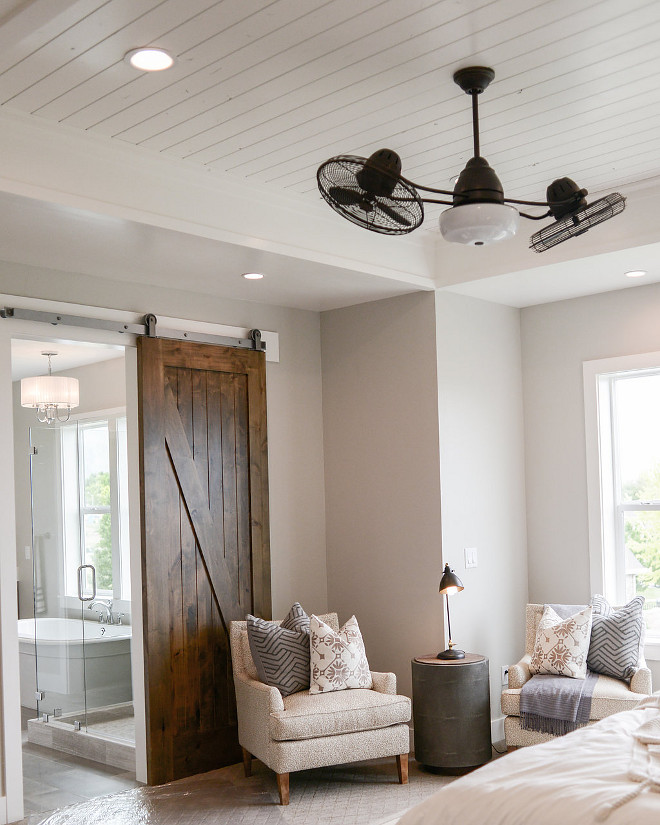 Master Bedroom barn door. A walnut-stained barn door opens to the master bathroom. #masterbedroombarndoor #barndoor Millhaven Homes