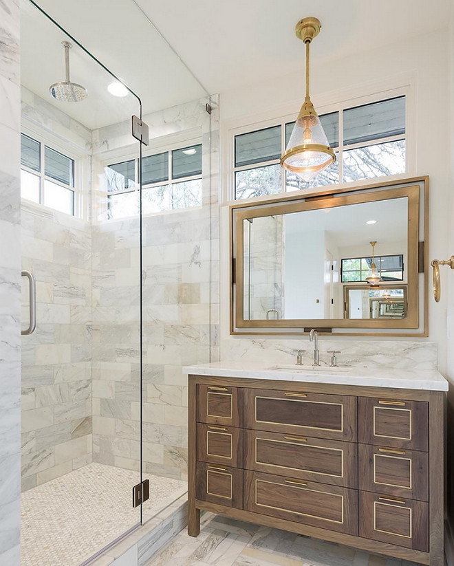 Bathroom Cabinet. Bathroom cabinet is a dark walnut with brass inlay. Bathroom floor tile is Calcutta marble. Cabinetry stain is a dark walnut with brass inlay. The plumbing fixtures are Kohler Purist. Light fixtures are Visual Comfort. #bathroom