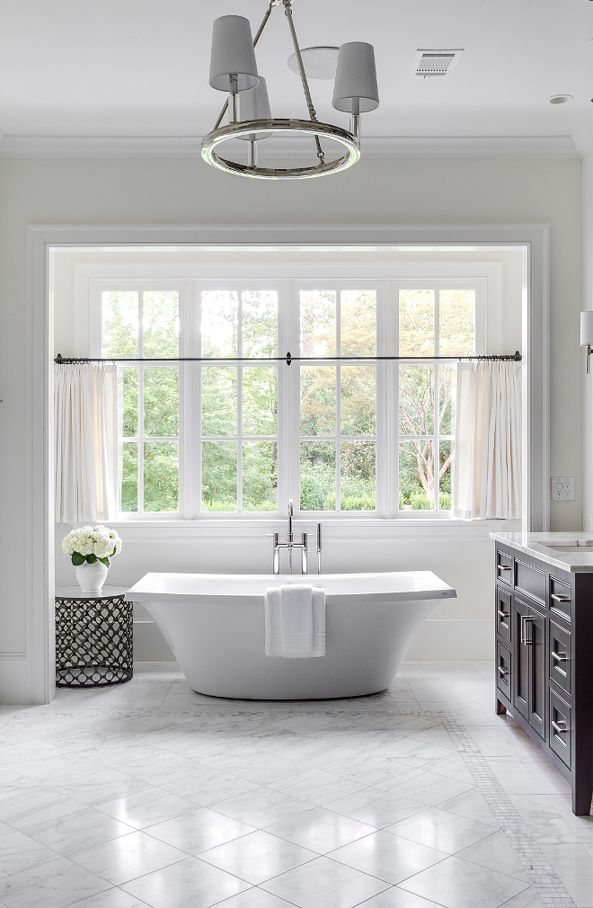 Bathroom flooring. Bathroom floor tile style. The master bathroom has Bianco Venato marble on the floor and shower walls. The designer created a rug for the floor by turning the tile on the diagonal and adding 3 rows of 1x1 as a border. #bathroom #Flooring #tile #Floortile #floorstyle Interiors by Courtney Dickey. Architecture by T.S. Adam Studio