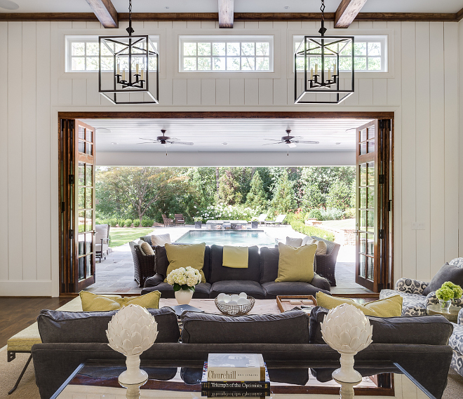 Living room doors. The best part of the living room is how it opens up to the outdoor area with custom folding doors. By opening the family room to the outdoors, it creates a great entertaining space with a lovely view of the pool. #livingroom #doors Interiors by Courtney Dickey. Architecture by T.S. Adam Studio.