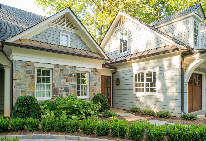 Exterior stone. The exterior of this home feature a mix of grey shingles and stone siding. Door stain is Provential with 20% brown tint added. #exteriorstone #stone #homeexterior Interiors by Courtney Dickey. Architecture by T.S. Adam Studio. exterior-stone