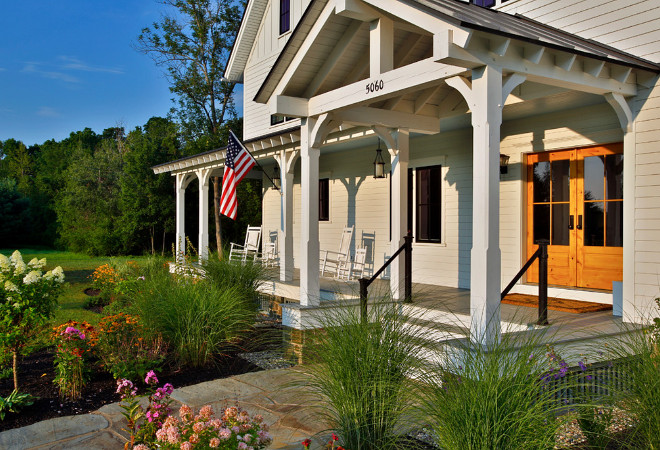 Farmhouse Porch. A traditionally styled farmhouse with all the comforts of a modern house. Farmhouse Porch #FarmhousePorch #Farmhouse #Porch Teakwood Builders, Inc. Scott Bergmann Photography