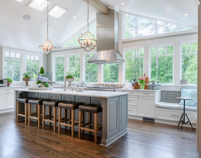Sherwin Williams Alabaster. Sherwin Williams Alabaster. Placing the kitchen where used to be a screened-in porch allowed the space to have tall, vaulted ceilings and lots of windows. The perimeter cabinets are painted in Sherwin Williams Alabaster. #SherwinWilliamsAlabaster Outrageous Interiors