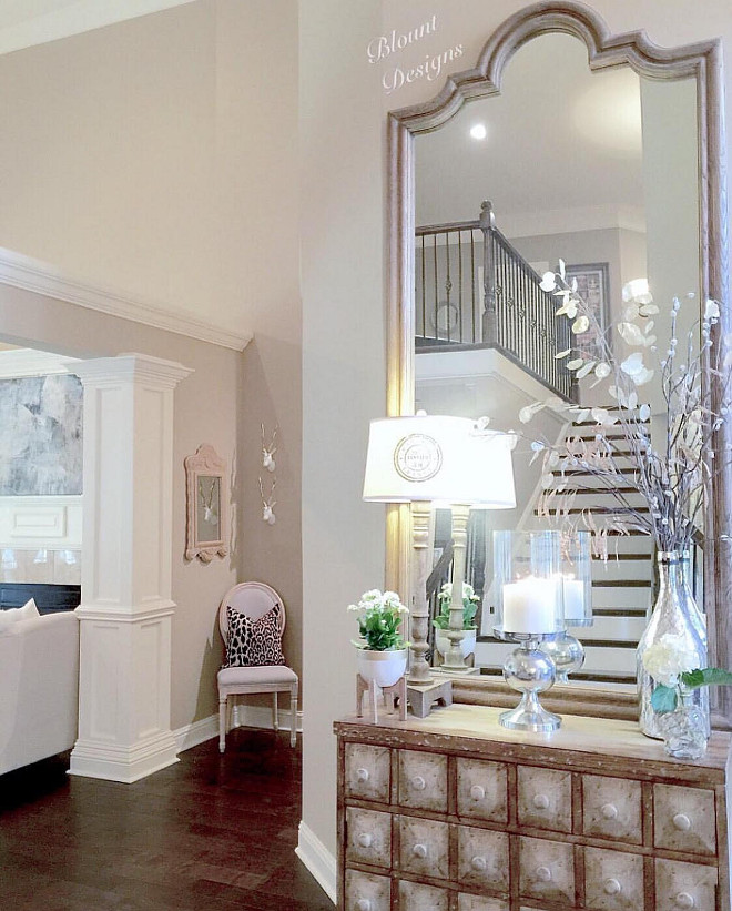 Foyer Furniture and Decor. Foyer furniture and decor ideas. Chest: Joss and Main. Corner chair, gray linen with natural wood frame and Reclaimed wood Levico 90"mirror: Restoration Hardware. Leopard Pillow: Etsy, Studio Tullia. Plant Stand: Target. Candleholder/hurricane, silver vase, French-inspired Lamp Shade: HomeGoods. Lamp: Pottery Barn. #foyer #foyerfurniture #foyerdecor #foyers Home Bunch Beautiful Homes of Instagram @blountdesigns