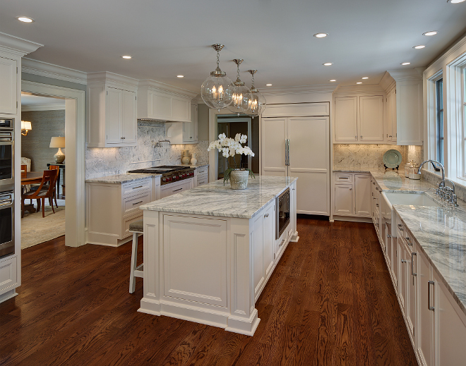 White kitchen renovation. A classic mix of polished nickel details and white cabinetry gives this white kitchen a clean and fresh face. #whitekitchenrenovation #whitekitchen #kitchen #renovation #reno W Design 